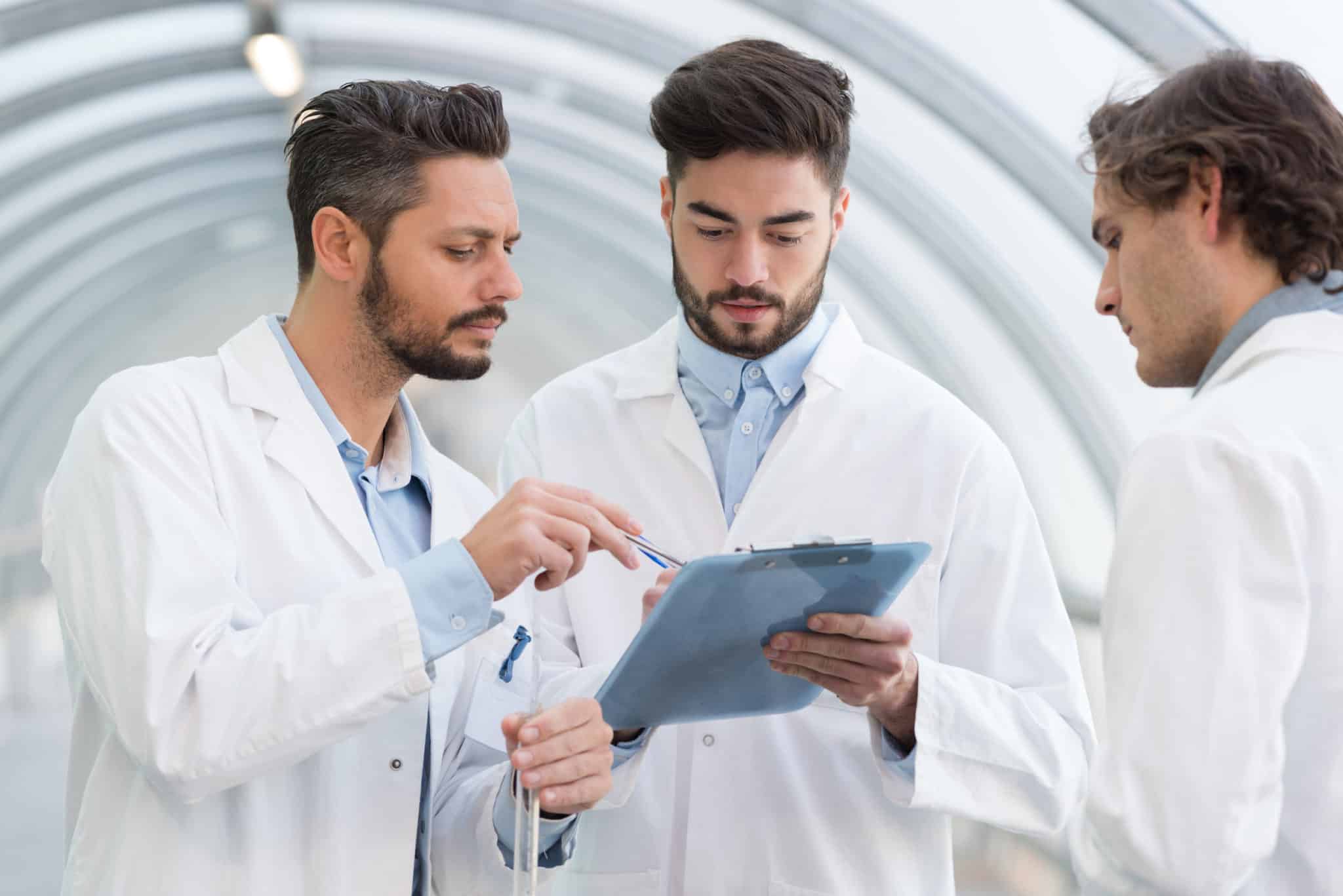 three scientists having a discussion