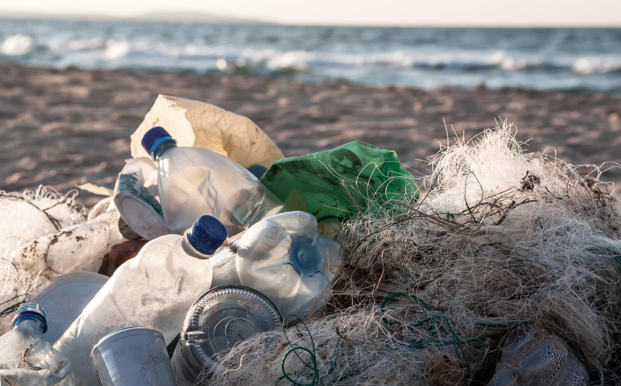 Plastic bottles and other trash on sea beach