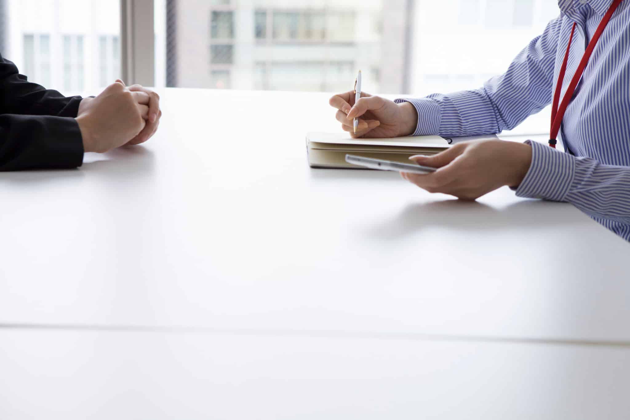 Businesswoman have an interview in the office face to face while taking notes