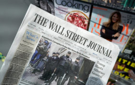 The Wall Street Journal newspaper in a hand