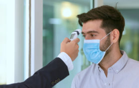 Receptionist and guest wearing face mask