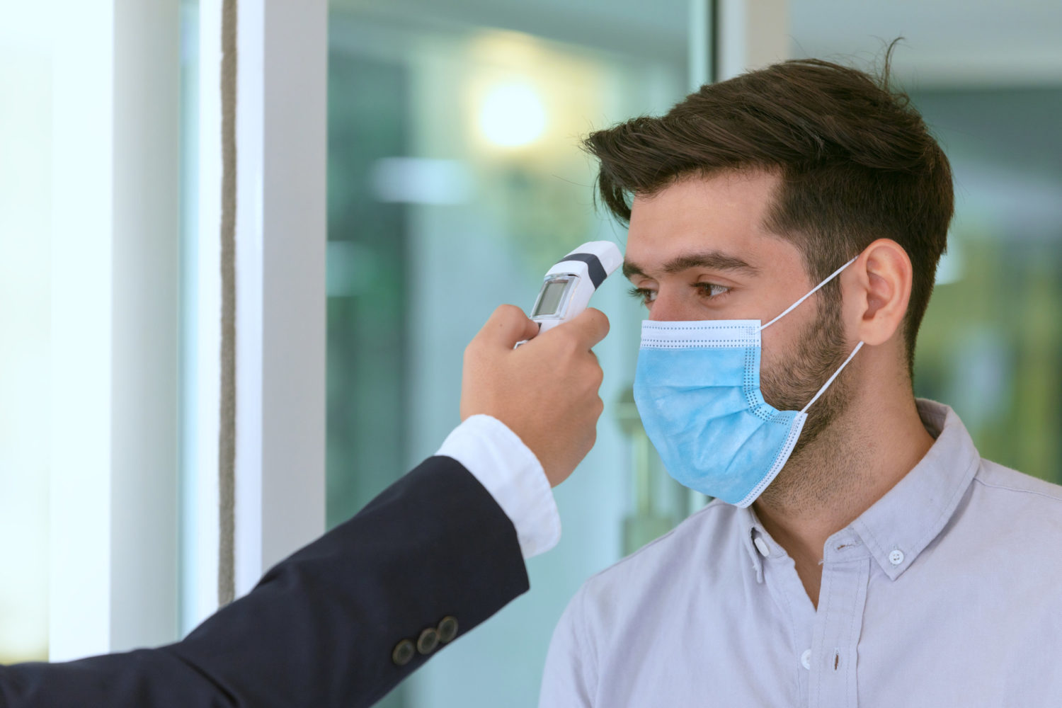 - This Nation Receptionist and guest wearing face mask