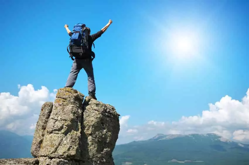 man climbs to the peak of the mountain