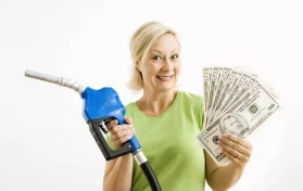 Woman at gas pump holding money