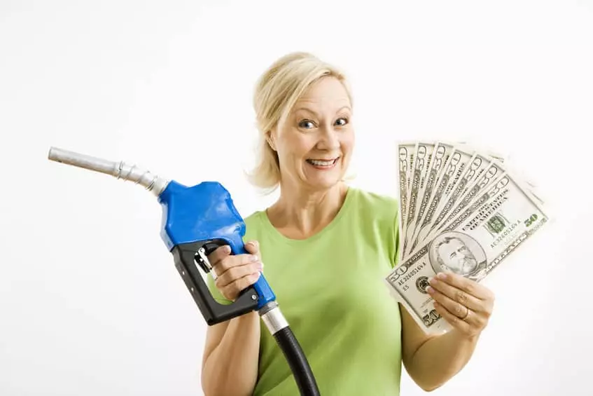 - This Nation Woman at gas pump holding money