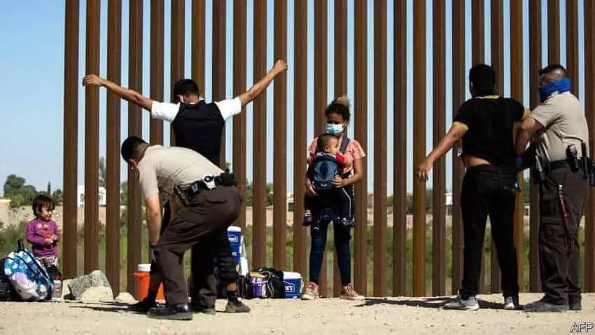 - This Nation illegal migrants at the border wall