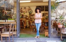 small business owner in front of her shop